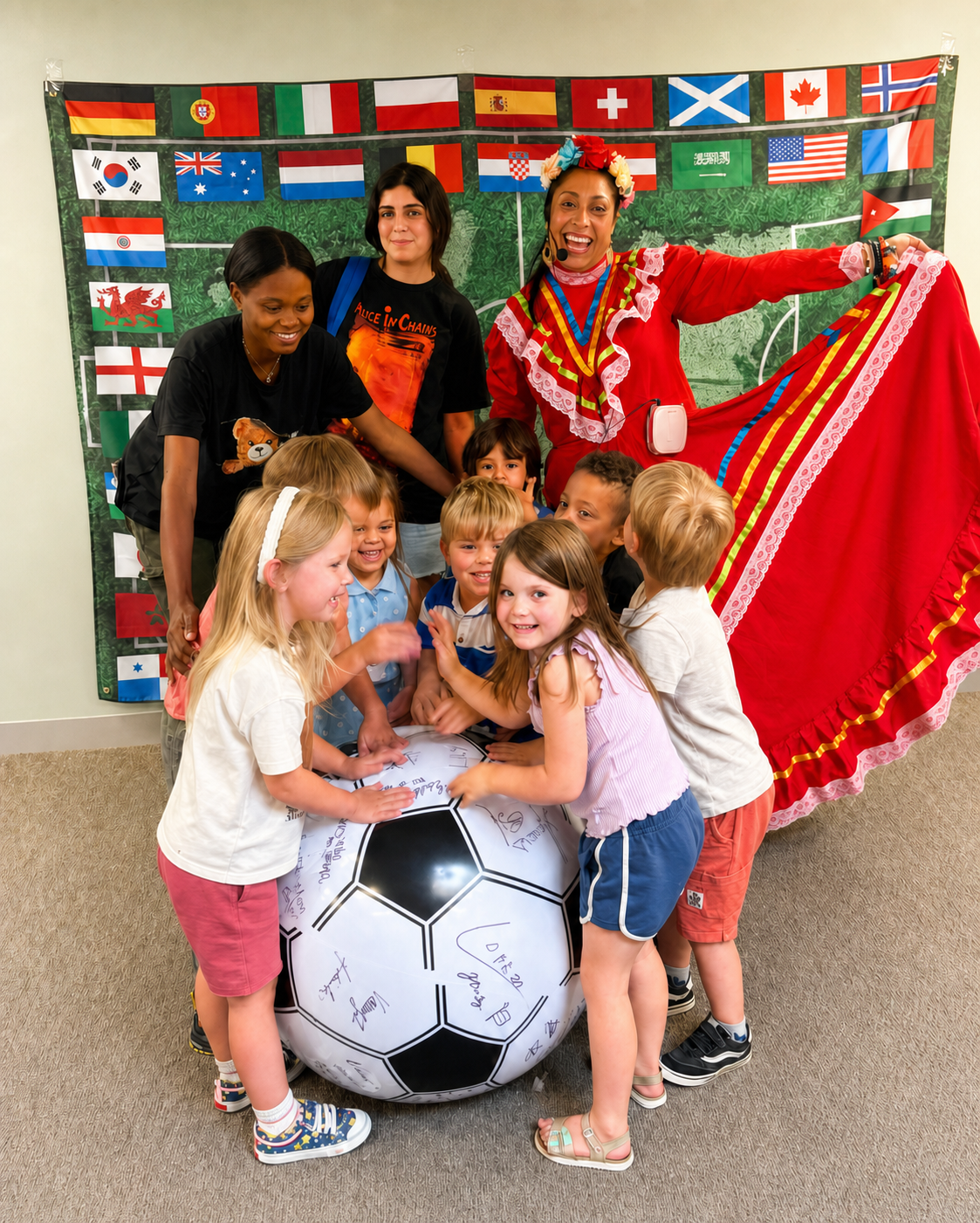 Children celebrating with an educator wearing a traditional Mexican dress